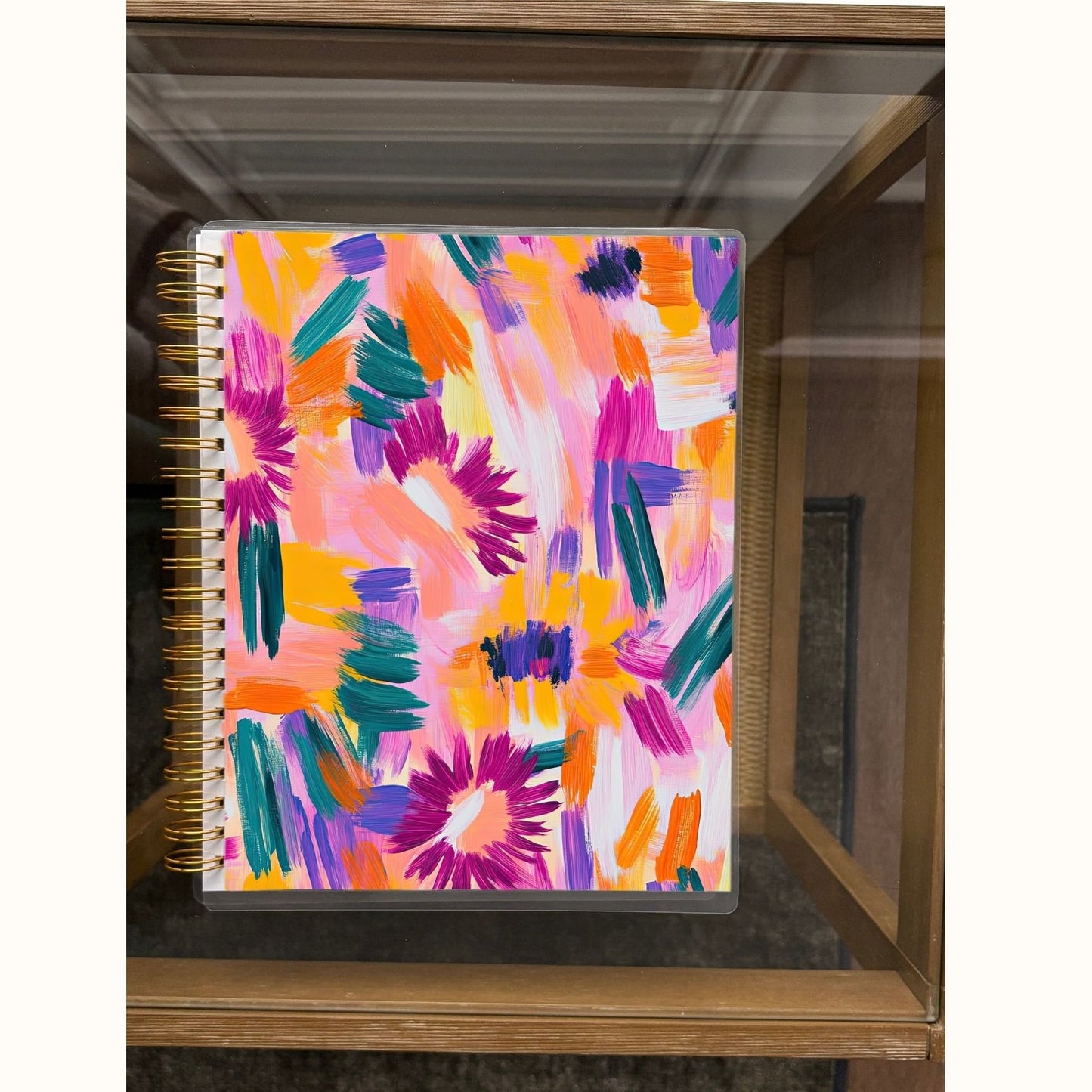 Colorful abstract patterned notebook on a wooden surface