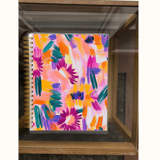 Colorful abstract patterned notebook on a wooden surface